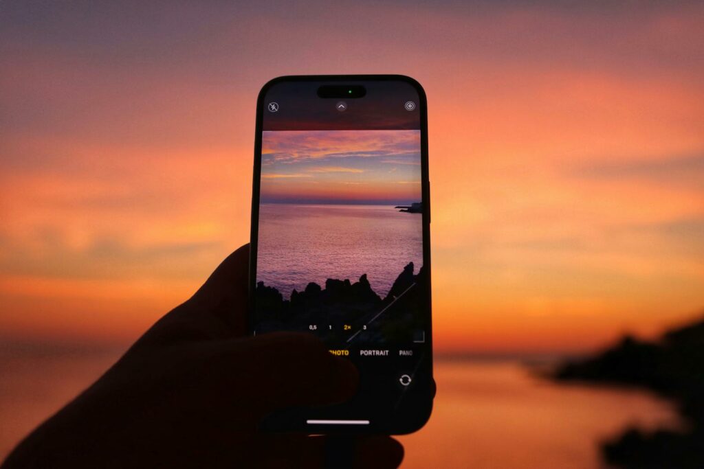 Beautiful sunset in Cefalù, Sicily, through a smartphone lens, highlighting vibrant sky colors.